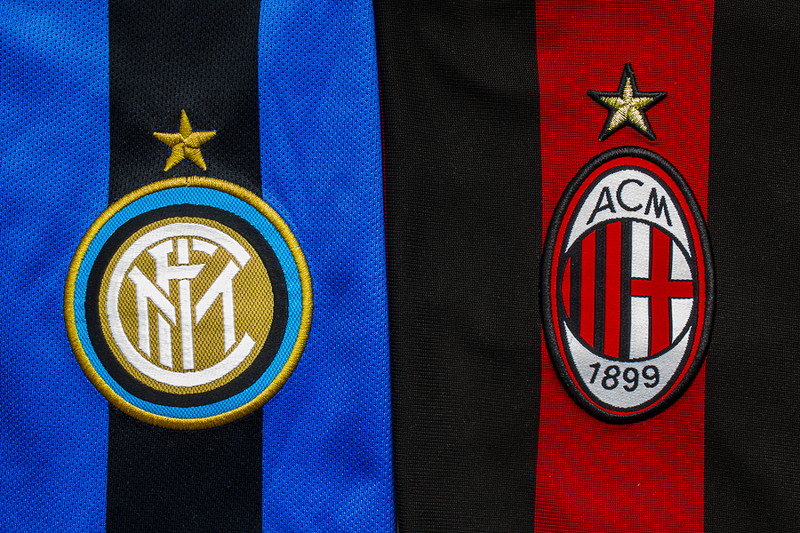 inter milan and ac milan shirts side by side with badges