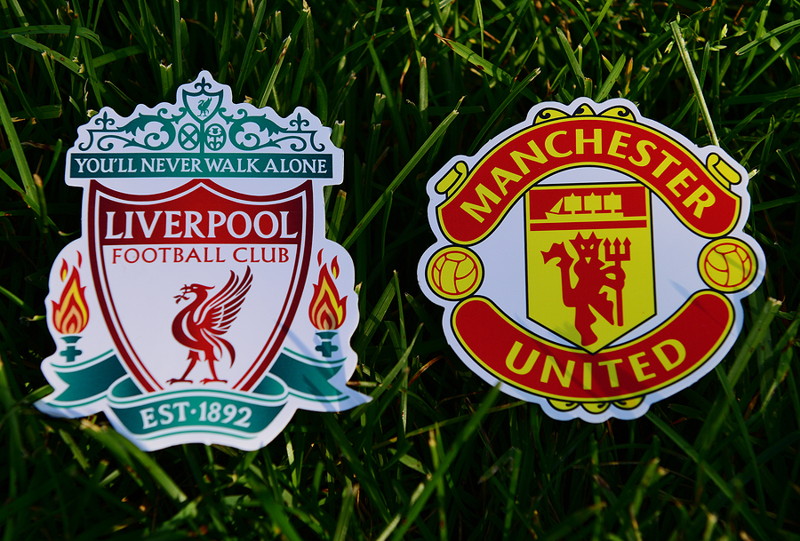 liverpool and manchester united crests rivals